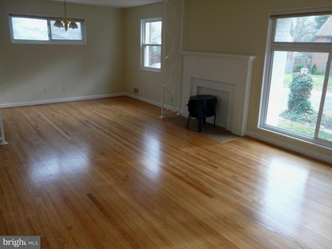 705 Stirling Road Silver Spring, MD 20901 - Photo 17 of 23 an empty room with wooden floor and windows