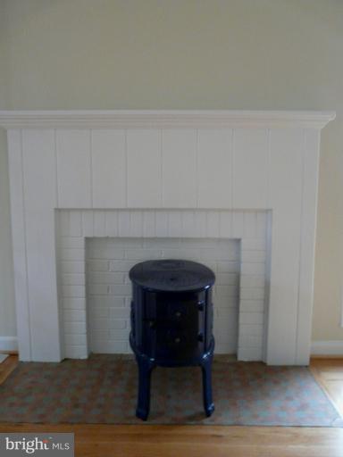 705 Stirling Road Silver Spring, MD 20901 - Photo 18 of 23 a hallway with a fireplace and wooden floor