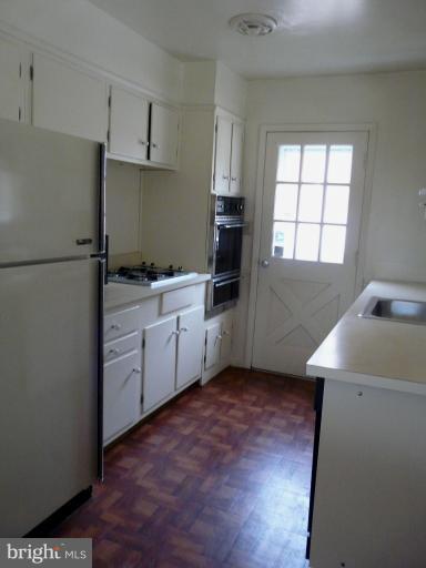 705 Stirling Road Silver Spring, MD 20901 - Photo 22 of 23 a kitchen with a sink a window and appliances