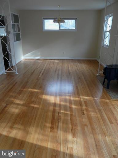 705 Stirling Road Silver Spring, MD 20901 - Photo 23 of 23 en empty room with wooden floor and windows