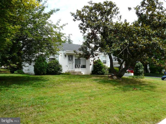 705 Stirling Road Silver Spring, MD 20901 - Photo 4 of 23 a view of a house with a big yard and large trees