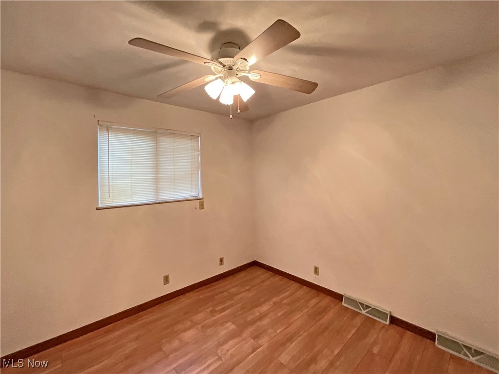 6568 Wylie Ridge Road New Cumberland, WV 26047 - Photo 14 of 28 Spare room with ceiling fan and hardwood / wood-style flooring