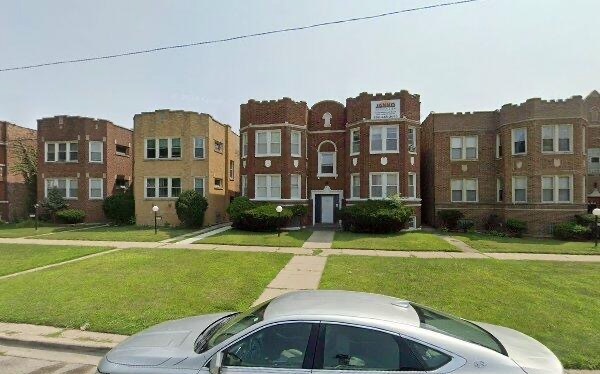 7951 South Prairie Avenue Chicago, IL 60619 - Photo 1 of 1 a front view of a house with a yard