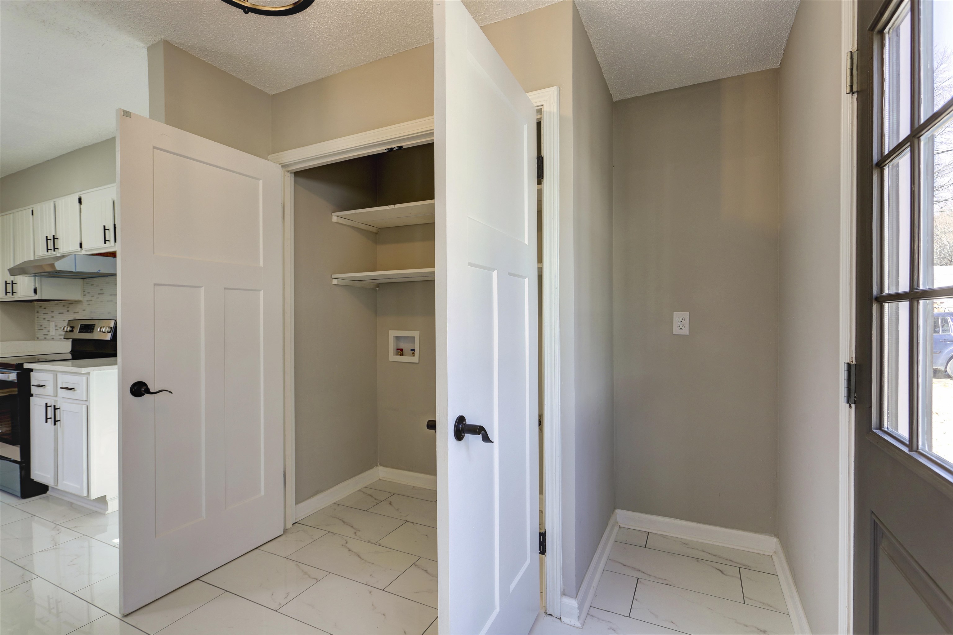 942 Wingfield Road Memphis, TN 38122 - Photo 13 of 24 a view of a kitchen from the hallway with a door and wooden floor