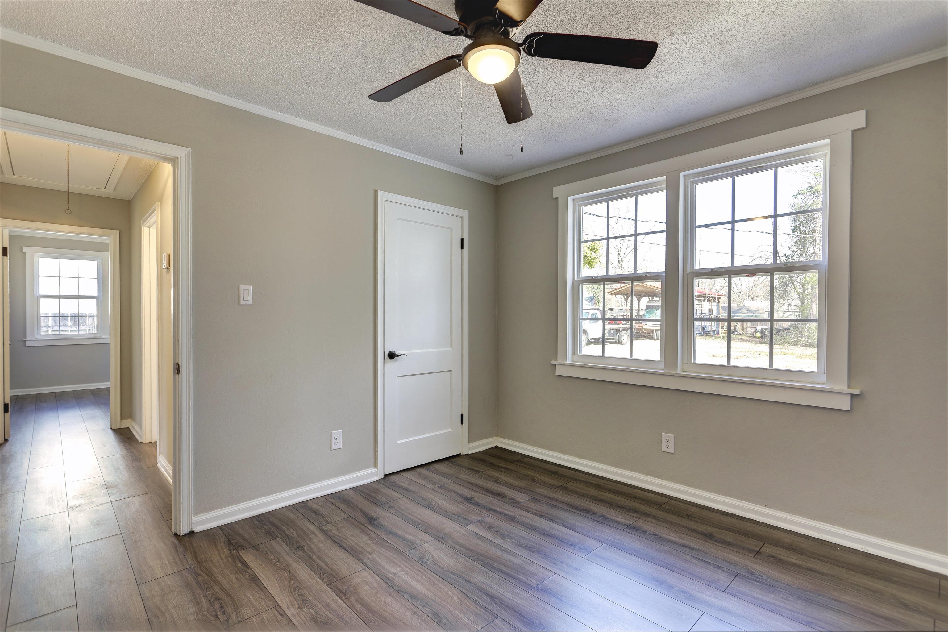 942 Wingfield Road Memphis, TN 38122 - Photo 18 of 24 a view of an empty room with wooden floor and a window