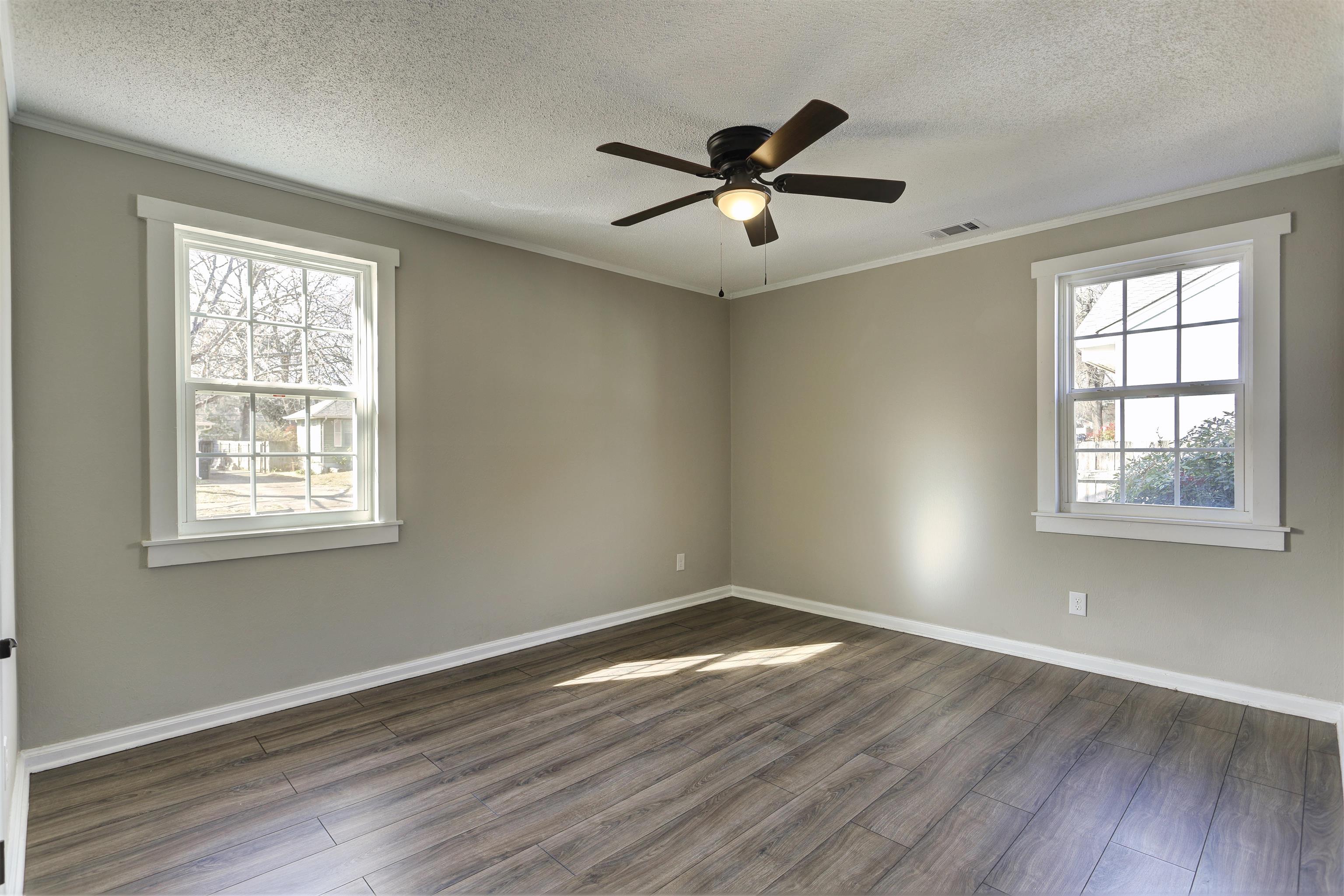 942 Wingfield Road Memphis, TN 38122 - Photo 22 of 24 a view of empty room with wooden floor and fan