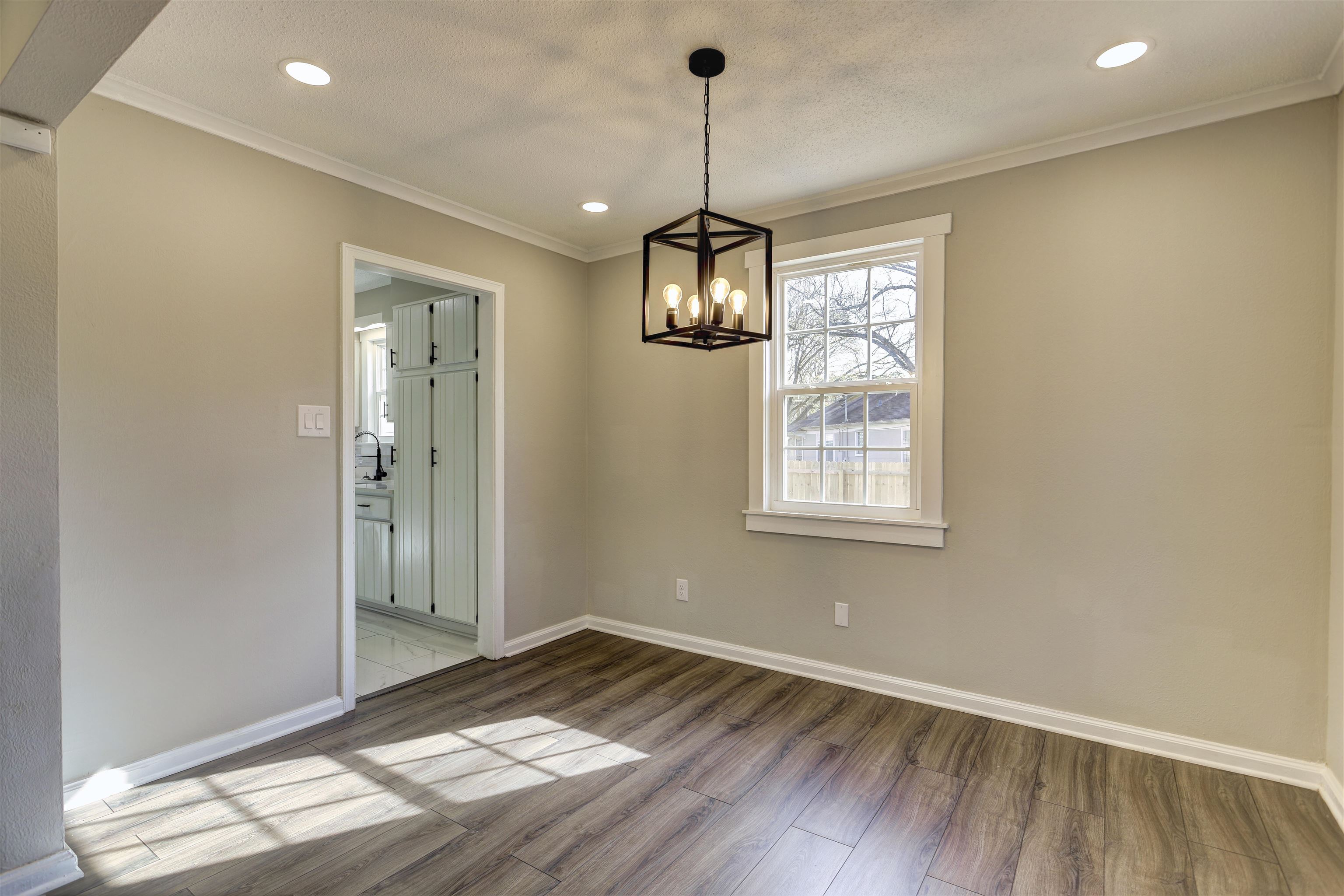 942 Wingfield Road Memphis, TN 38122 - Photo 8 of 24 a view of empty room with wooden floor and fan