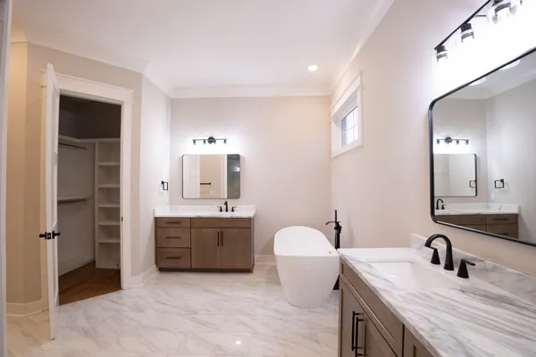 a bathroom with a granite countertop sink double vanity and a mirror