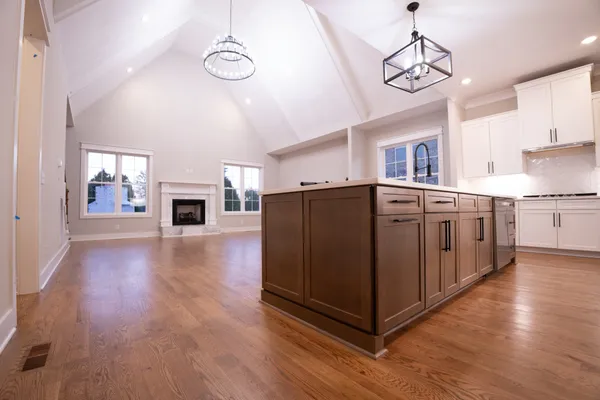 a view of kitchen with granite countertop cabinets and wooden floor
