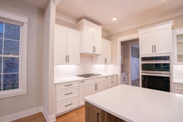 a kitchen with a stove a refrigerator and a sink