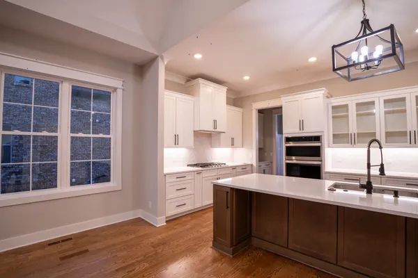 a kitchen with granite countertop a stove and cabinets