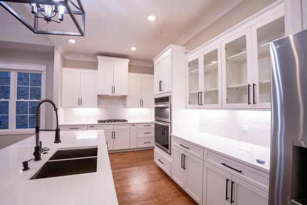 a kitchen with stainless steel appliances granite countertop a stove and a sink