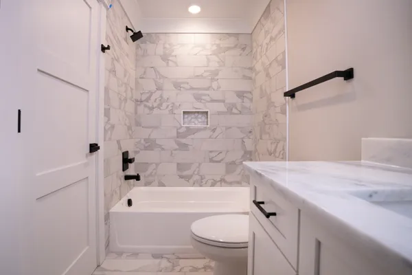 a spacious bathroom with a toilet a sink and a mirror