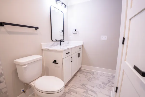 wooden floor and a bathroom with mirror