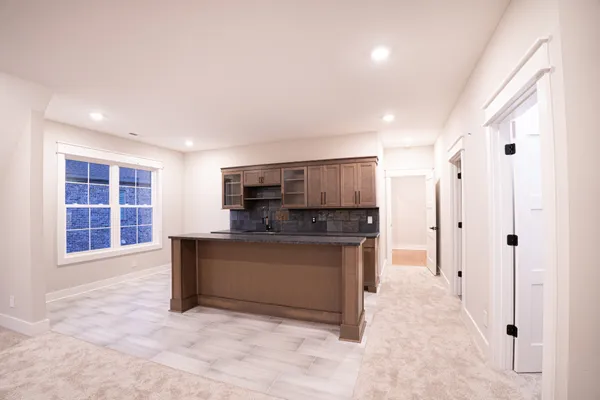 a kitchen with stainless steel appliances granite countertop a sink stove and cabinets