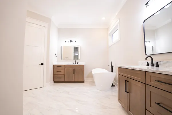 a spacious bathroom with a double vanity sink mirror and toilet