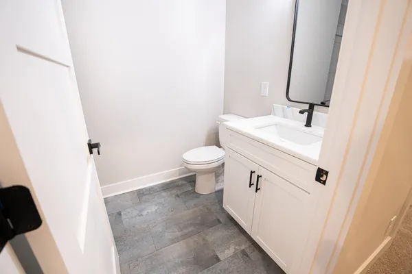 a spacious bathroom with a sink and a mirror
