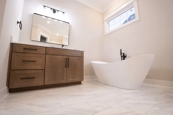 a bathroom with a bathtub and a mirror