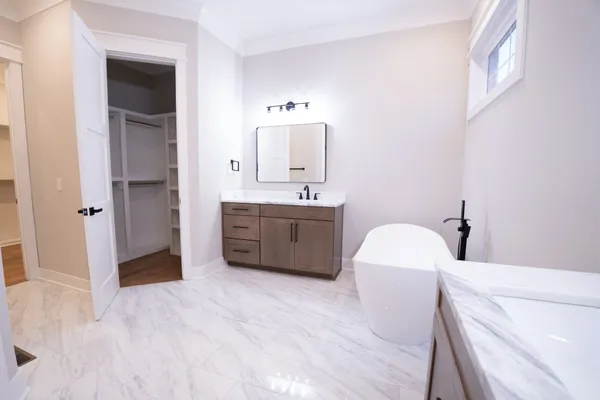 a bathroom with a tub sink and mirror