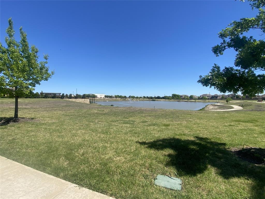 813 Mildren Lane Fate, TX 75087 - Photo 28 of 32 The pond with lots of green space as well as a biking/jogging trail