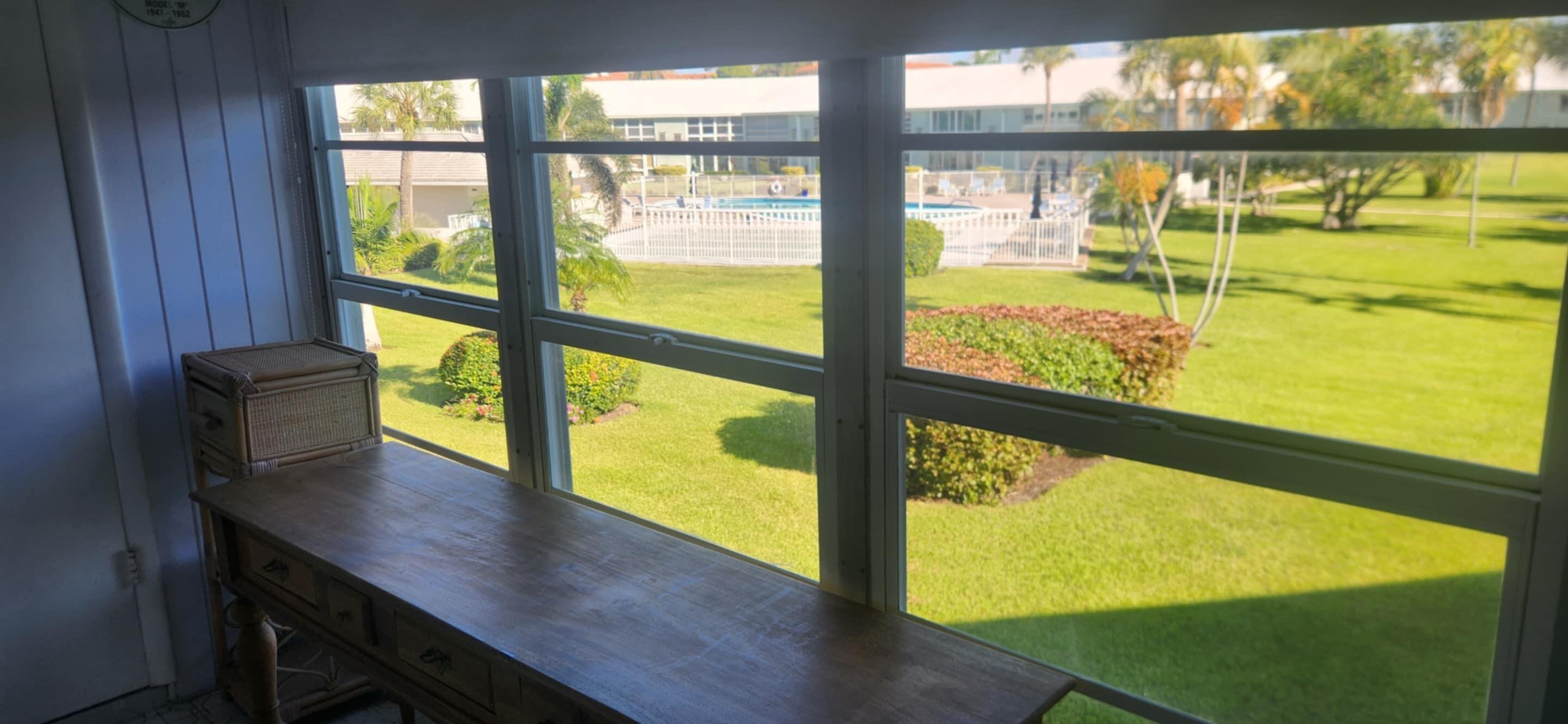 5510 North Ocean Boulevard, Unit 206 Ocean Ridge, FL 33435 - Photo 12 of 23 a view of a room with wooden floor and windows