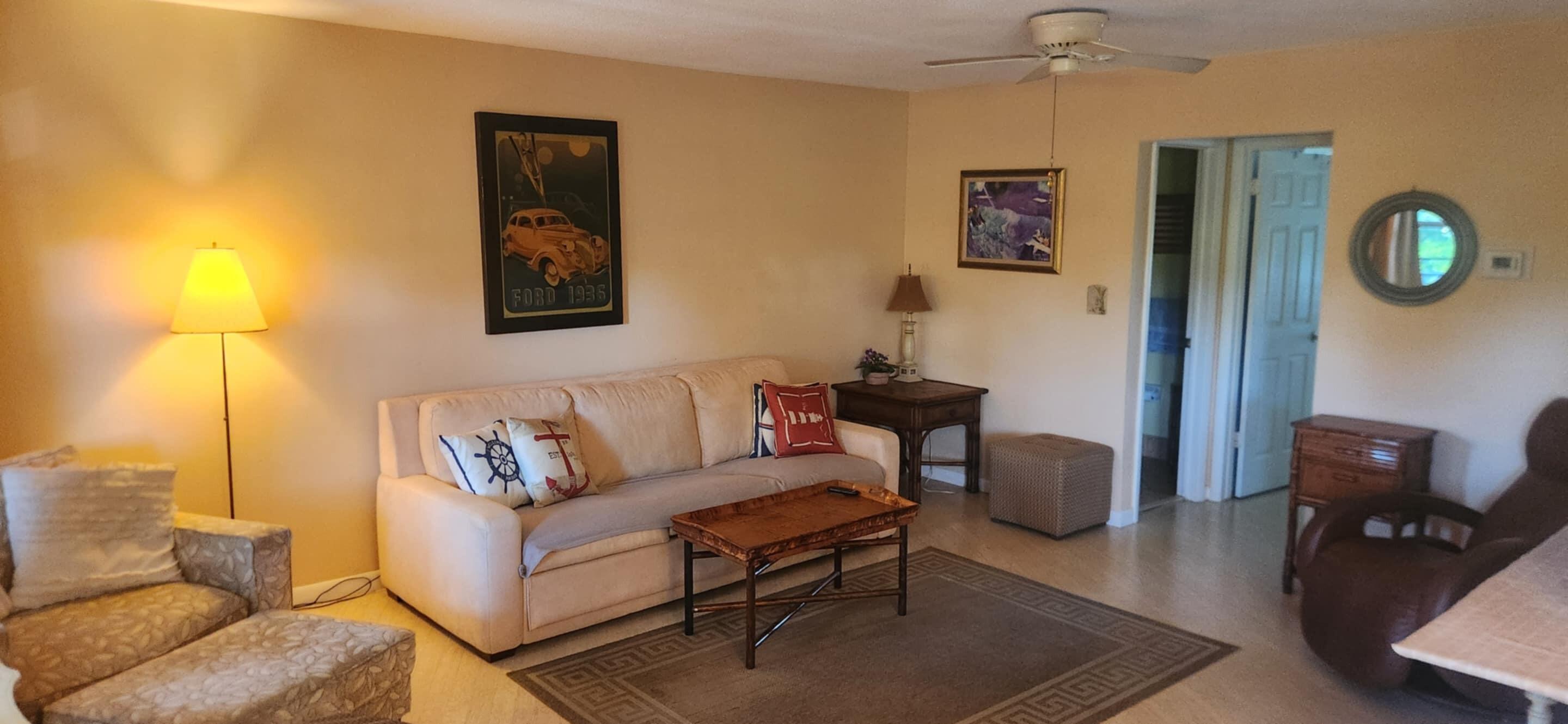 5510 North Ocean Boulevard, Unit 206 Ocean Ridge, FL 33435 - Photo 4 of 23 a living room with furniture and a lamp