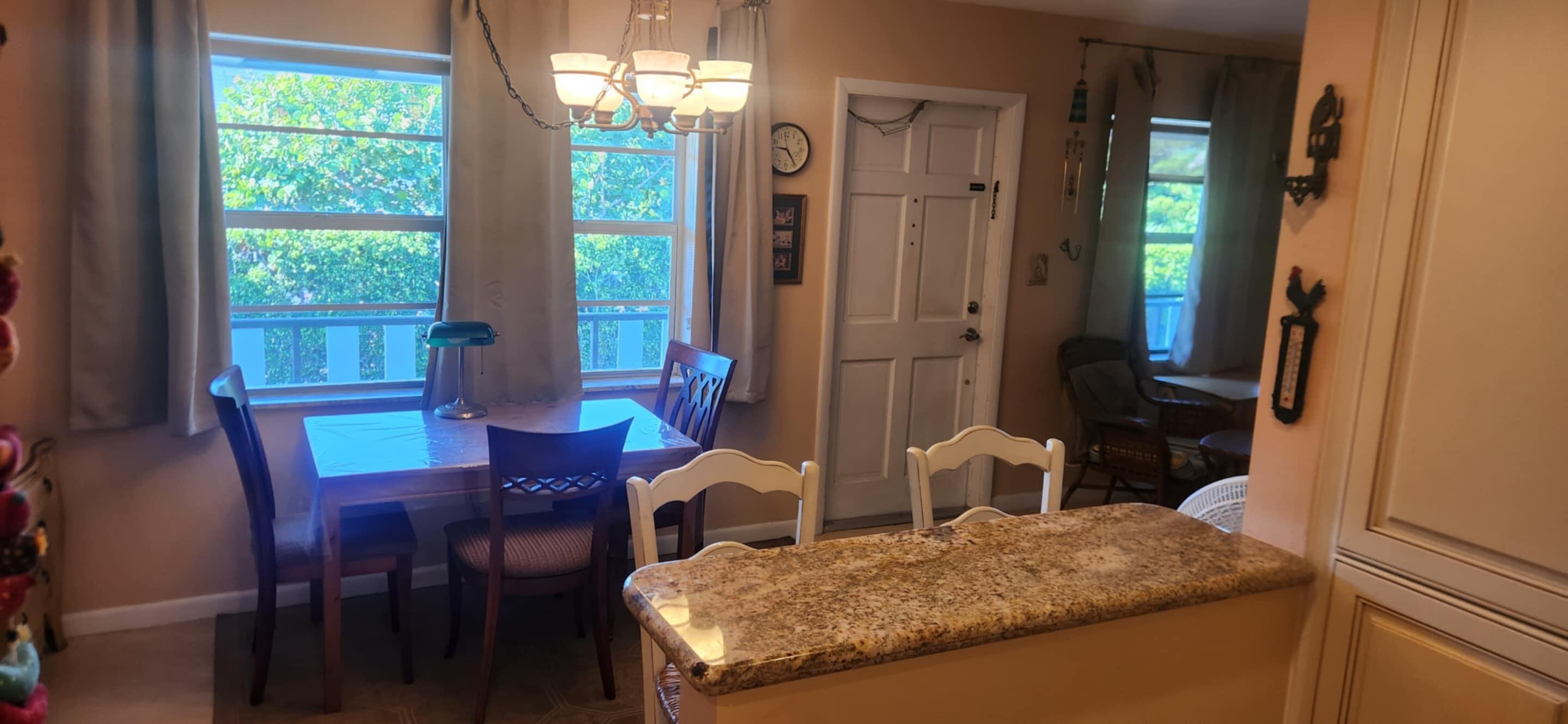 5510 North Ocean Boulevard, Unit 206 Ocean Ridge, FL 33435 - Photo 6 of 23 a view of a dining room with furniture and window