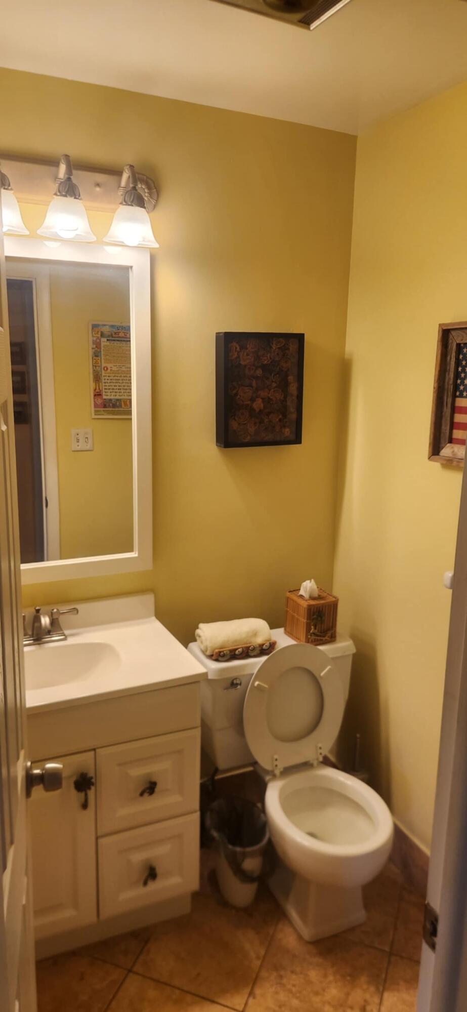 5510 North Ocean Boulevard, Unit 206 Ocean Ridge, FL 33435 - Photo 7 of 23 a bathroom with a toilet sink and mirror
