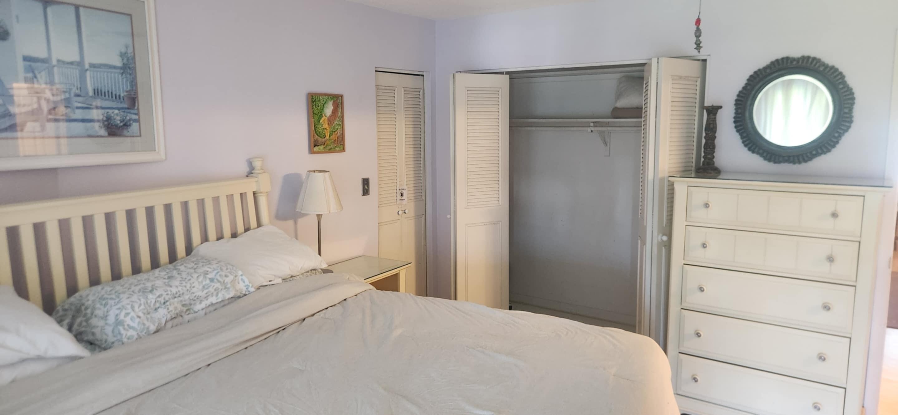 5510 North Ocean Boulevard, Unit 206 Ocean Ridge, FL 33435 - Photo 9 of 23 a bedroom with a bed and mirror