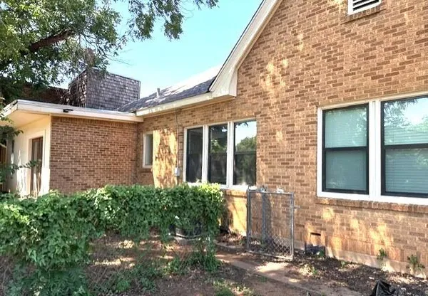 front view of a brick house with a large window