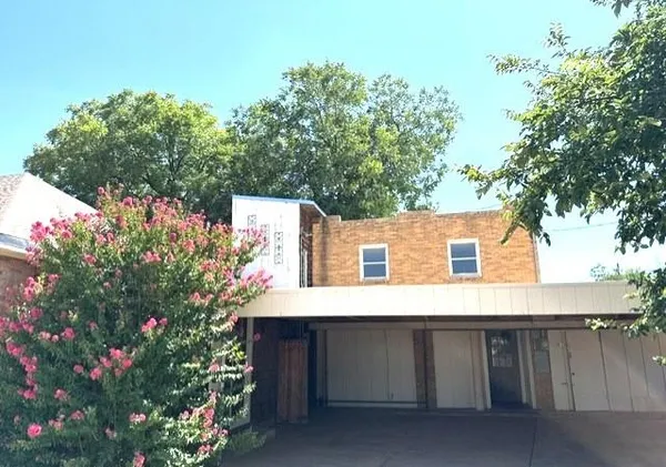 a view of a house with a flower garden