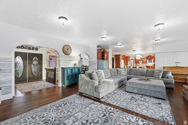2342 Charros Road Sandy, UT 84092 - Photo 15 of 94 Spacious living area featuring wood-finish flooring, recessed lighting, and a broad arched entryway