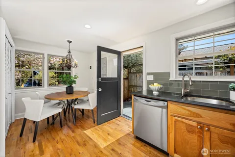 a kitchen with granite countertop sink dining table and chairs