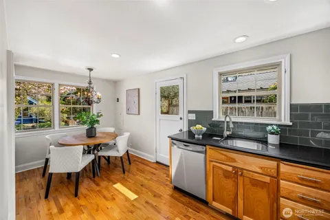 a dining room with granite countertop a sink and a large window