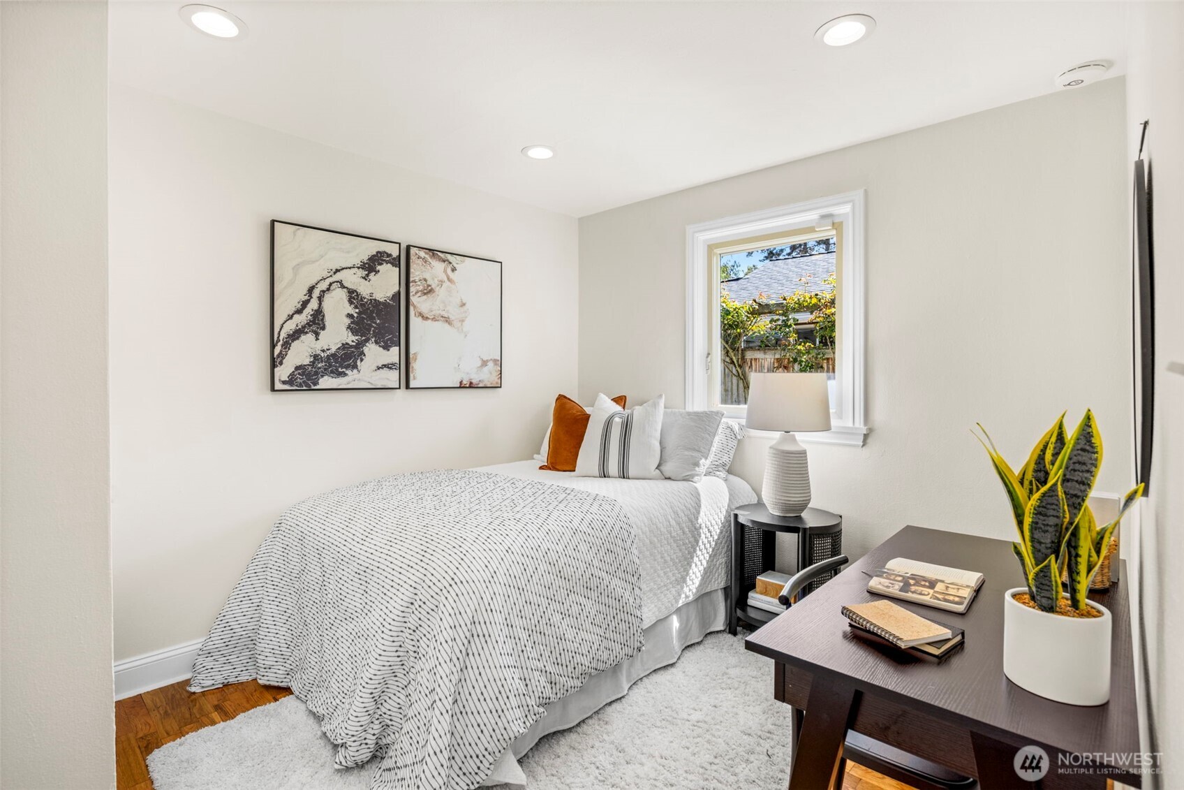 3321 35th Avenue South Seattle, WA 98144 - Photo 18 of 33 a bedroom with a bed and a table with potted plant