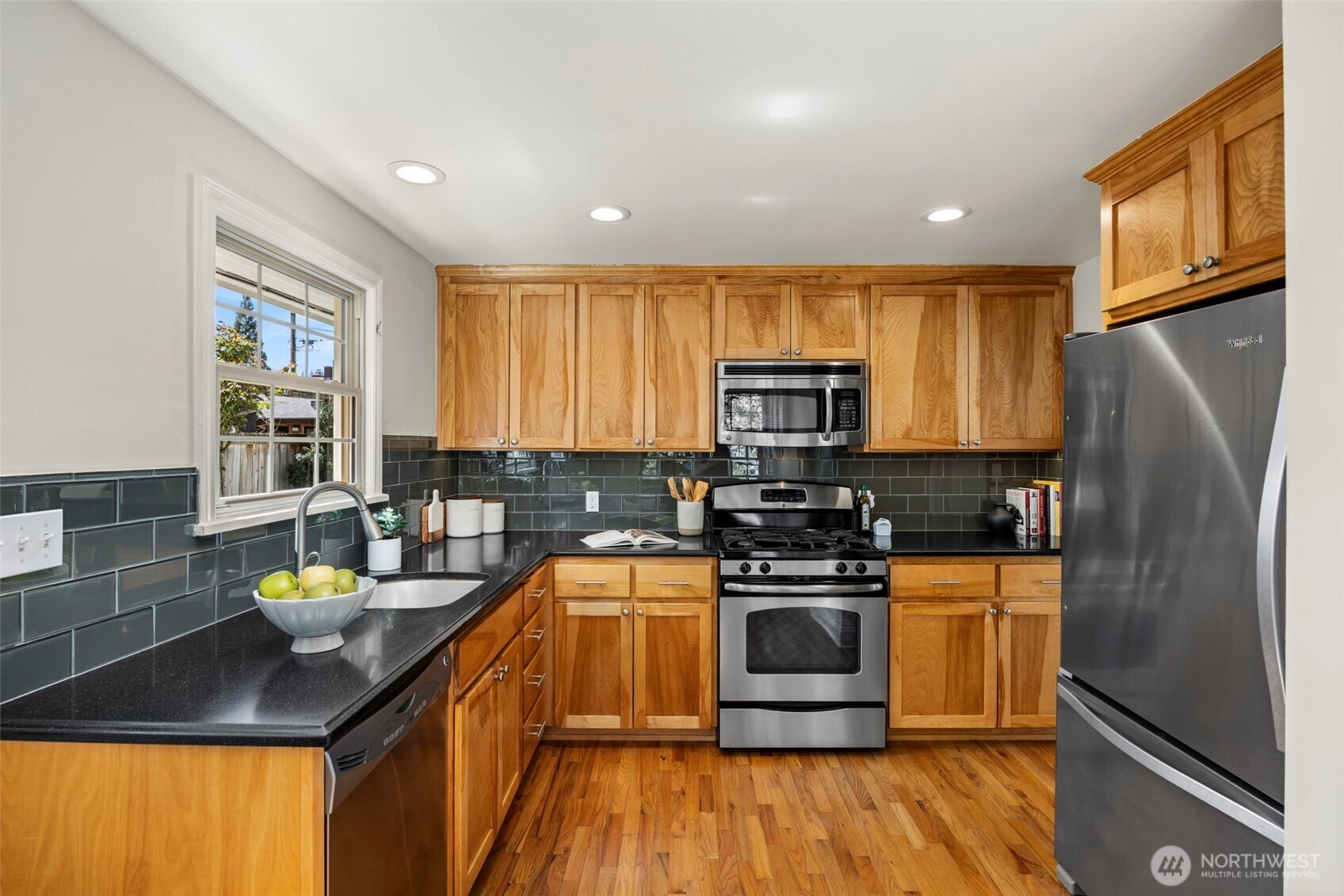 3321 35th Avenue South Seattle, WA 98144 - Photo 10 of 33 a kitchen with stainless steel appliances granite countertop a stove a sink and a refrigerator
