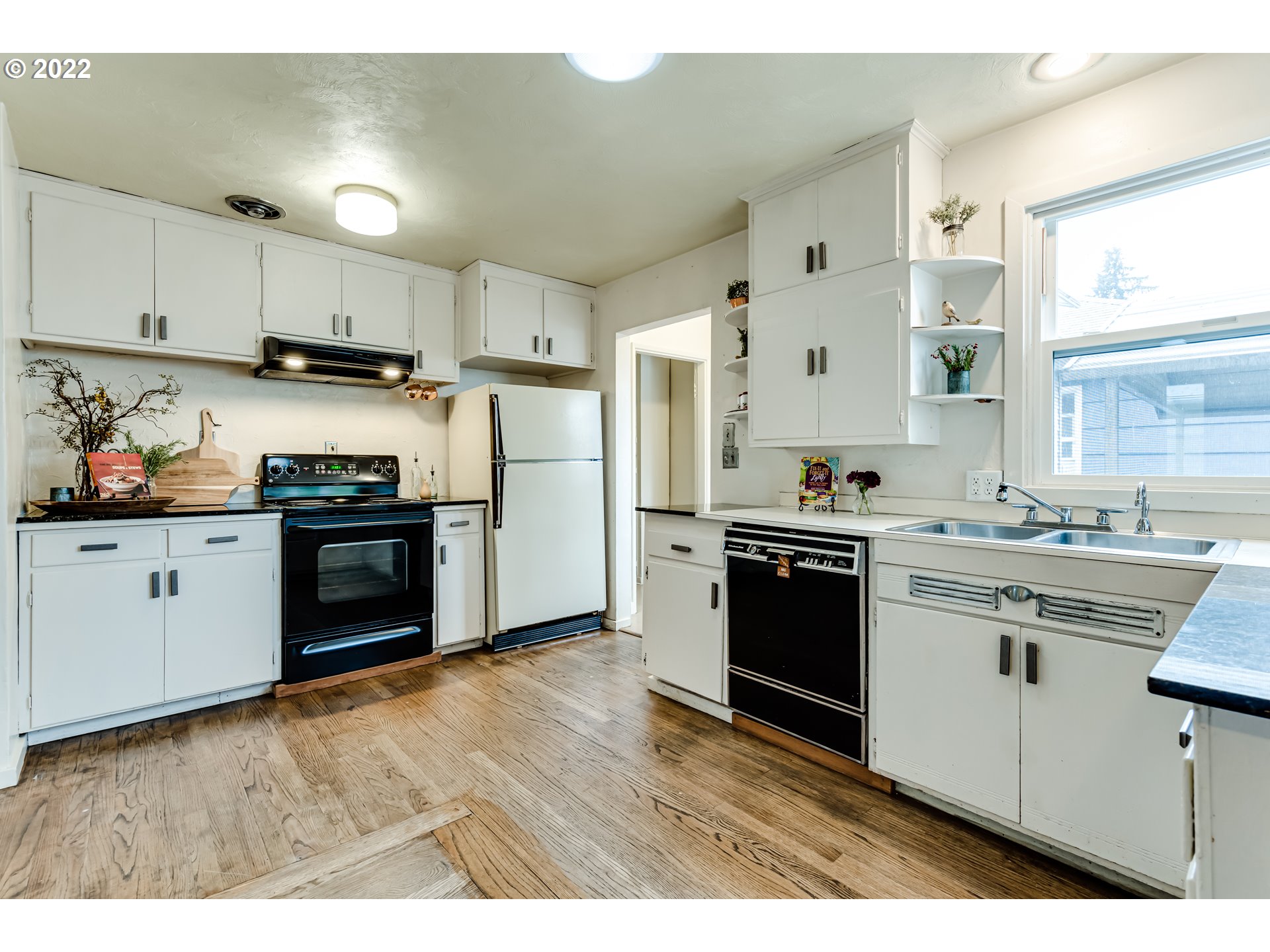 2261 5th Street Springfield, OR 97477 - Photo 13 of 27 a kitchen with stainless steel appliances granite countertop a stove a sink and white cabinets