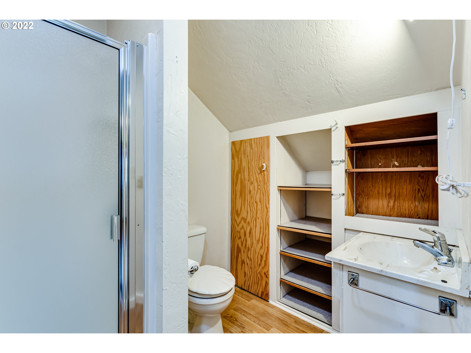2261 5th Street Springfield, OR 97477 - Photo 23 of 27 a bathroom with a sink a toilet and shower