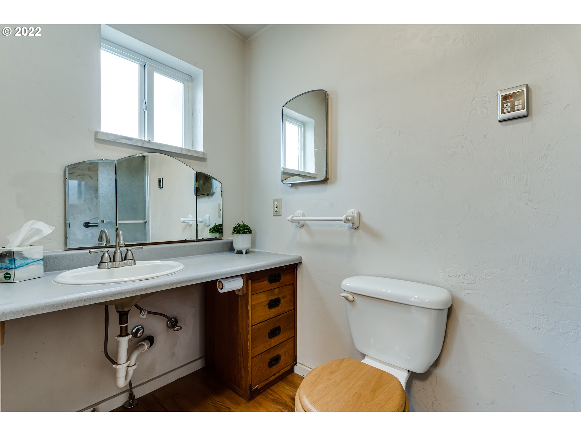 2261 5th Street Springfield, OR 97477 - Photo 8 of 27 a bathroom with a toilet a sink and mirror