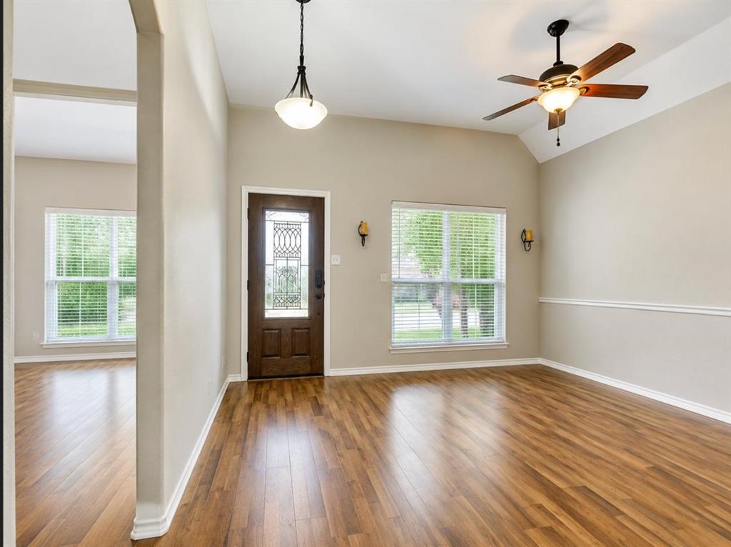 9962 Bell Rock Road Frisco, TX 75035 - Photo 2 of 28 a view of an empty room with wooden floor and a window