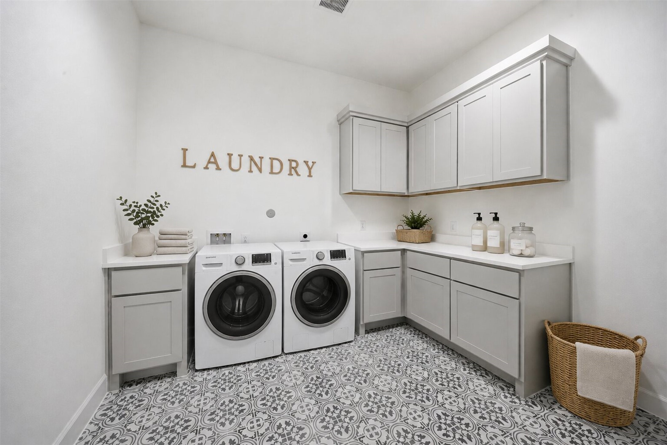 416 Venado View Court Conroe, TX 77304 - Photo 24 of 34 **Virtually Staged** Spacious laundry room thoughtfully designed with extensive custom cabinetry, abundant counter space, designer patterned tile flooring, and functionality that blends everyday convenience with elevated style.