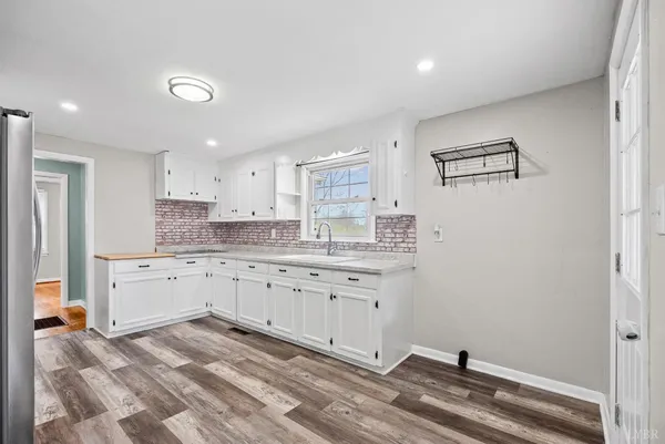 a room with granite countertop cabinets and sink