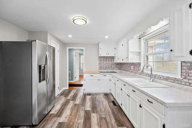a large kitchen with a lot of counter space and stainless steel appliances