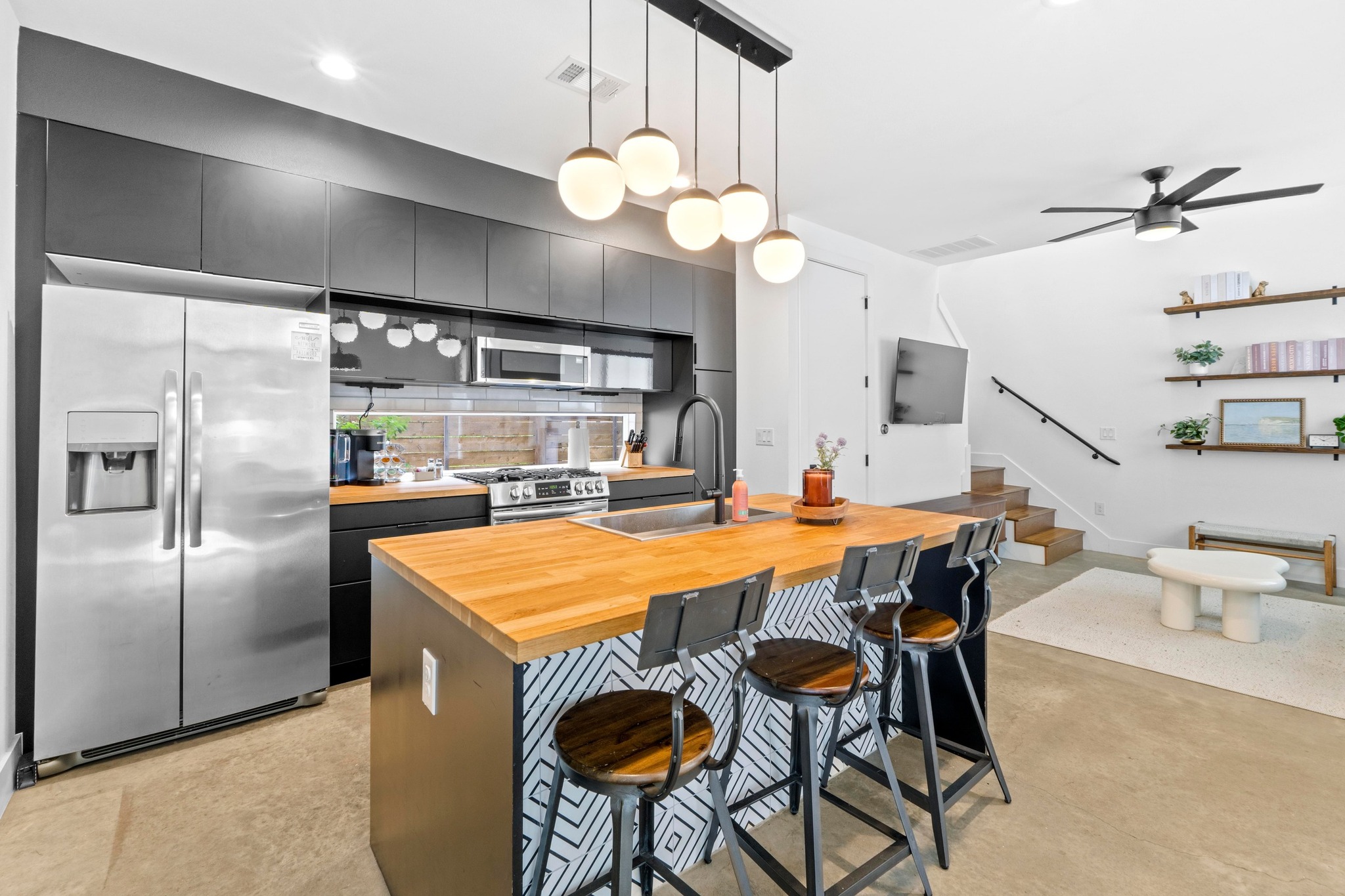 1706 Perez Street, Unit 2 Austin, TX 78721 - Photo 8 of 29 A well-appointed kitchen features a large center island and modern appliances, flowing into an inviting living space.