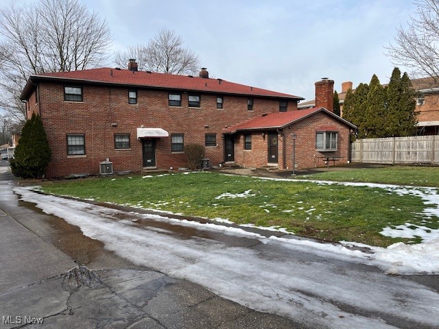 329-331 Kenridge Road Akron, OH 44333 - Photo 5 of 5 Rear view of property featuring a yard and cooling unit