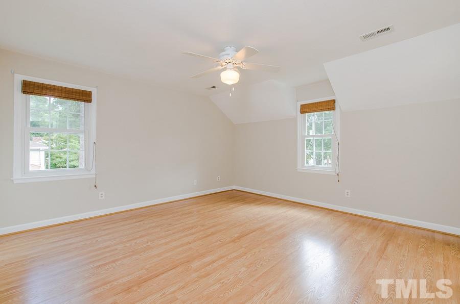 2705 Wycliff Road Raleigh, NC 27607 - Photo 13 of 22 a view of empty room with wooden floor and fan