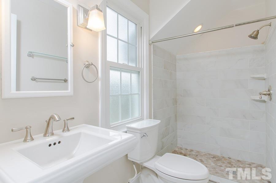 2705 Wycliff Road Raleigh, NC 27607 - Photo 14 of 22 a bathroom with a sink toilet and shower
