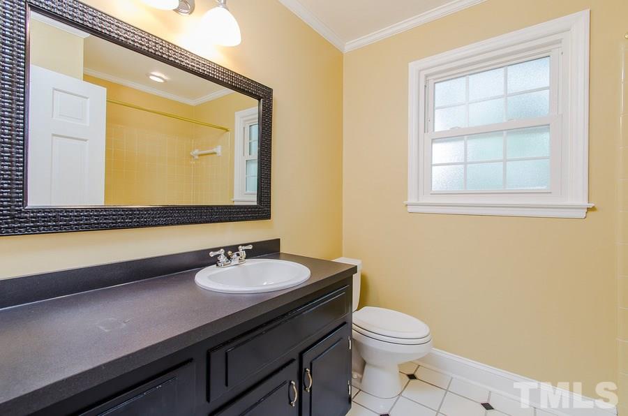 2705 Wycliff Road Raleigh, NC 27607 - Photo 18 of 22 a bathroom with a sink a toilet and mirror