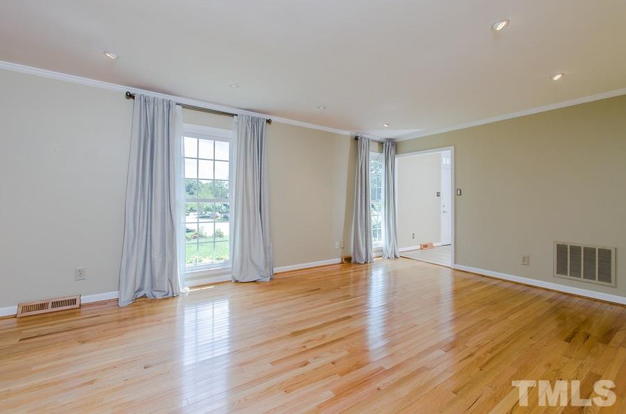 2705 Wycliff Road Raleigh, NC 27607 - Photo 5 of 22 a view of an empty room with wooden floor and a window