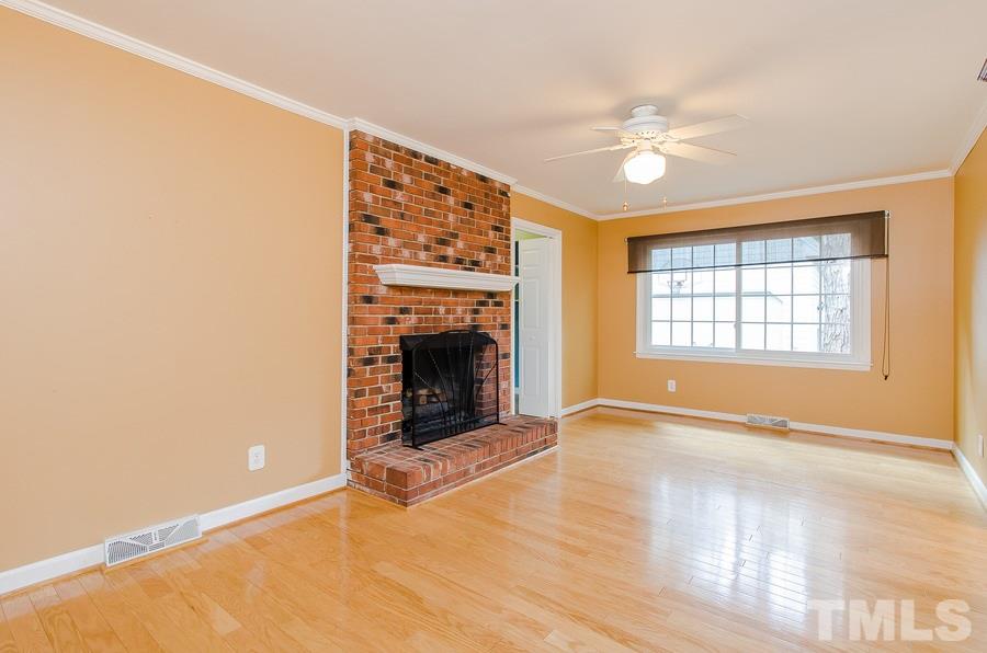 2705 Wycliff Road Raleigh, NC 27607 - Photo 7 of 22 an empty room with windows and fireplace